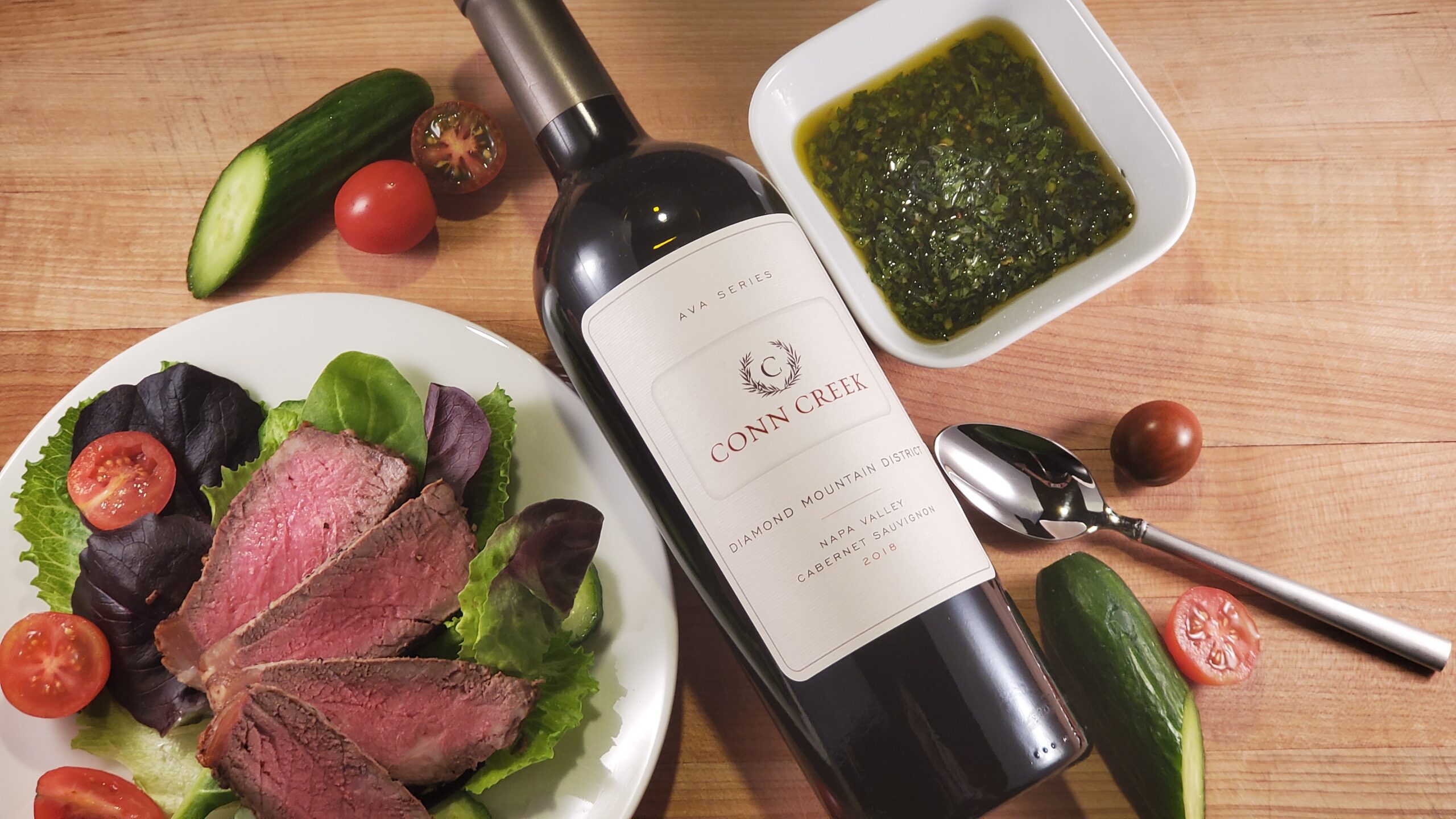 Chimichurri Steak Salad beside a bottle of Wine