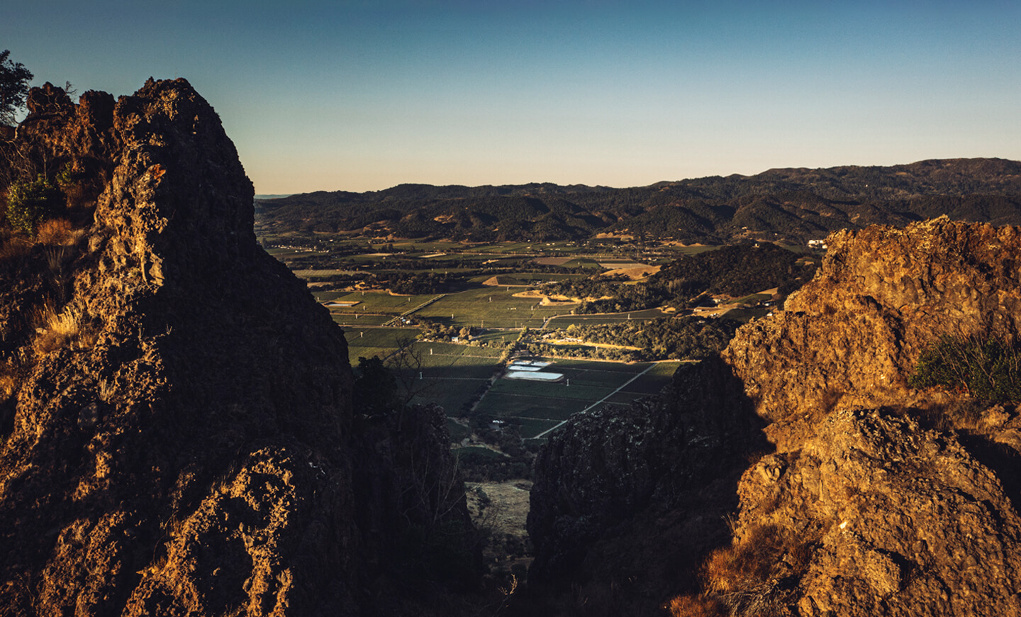 Aerial View of Stag's Leap Wine Cellars looking out at the vast vineyards at sunrise from between the peaks of the Stags Leap Palisades.