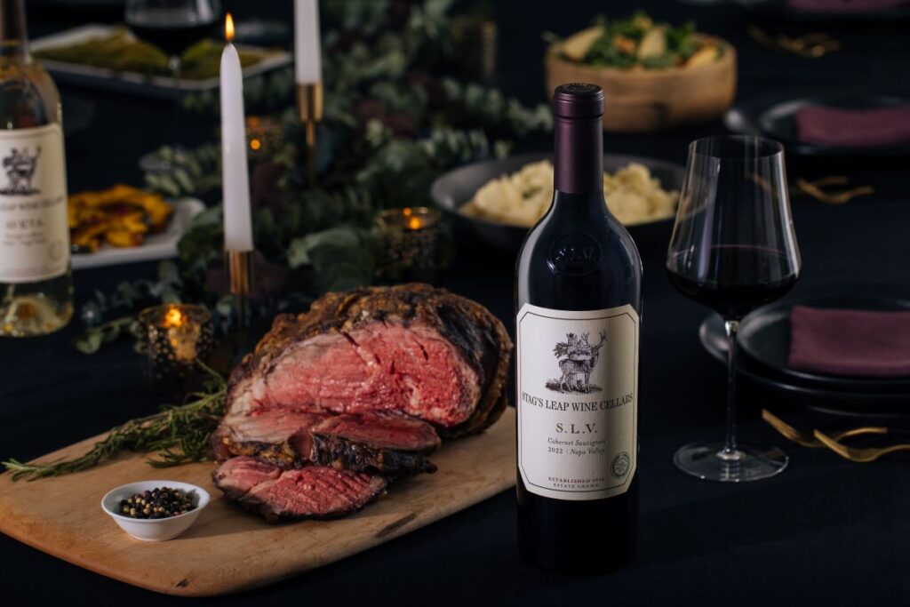 Finished prime rib au jus with bottle of SLV on holiday table