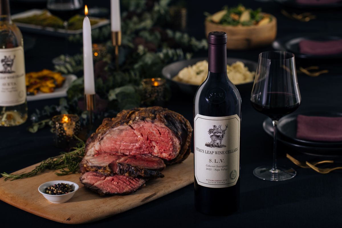 Finished prime rib au jus with bottle of SLV on holiday table